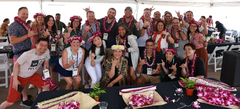 A group of EO members in Hawaii celebrate with beautiful flower leis.