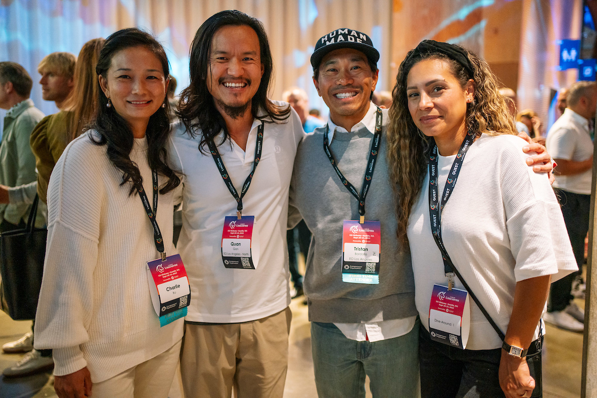 Four entrepreneurs stand together with confident smiles.