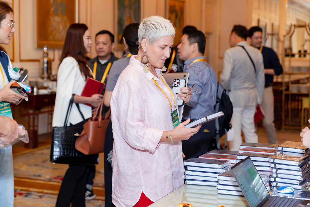 A 2025 APAC RLS attendee admires a book.