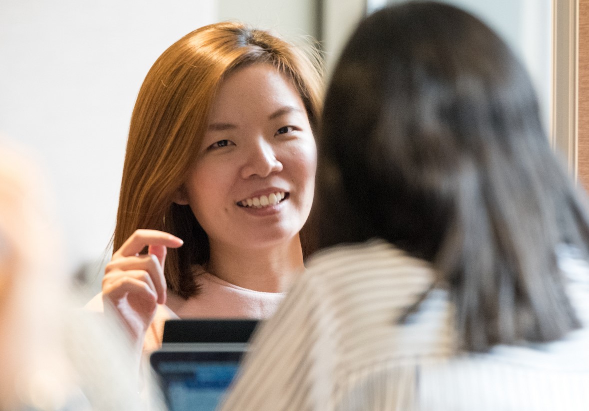 A female leader gives feedback to a team member.