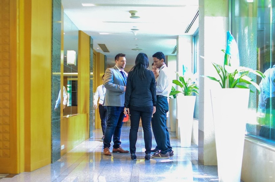 Four leaders meet for an operational audit to improve business efficiency.