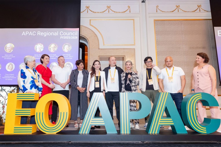 Ten EO regional leaders stand onstage behind a large "EO APAC" sign.