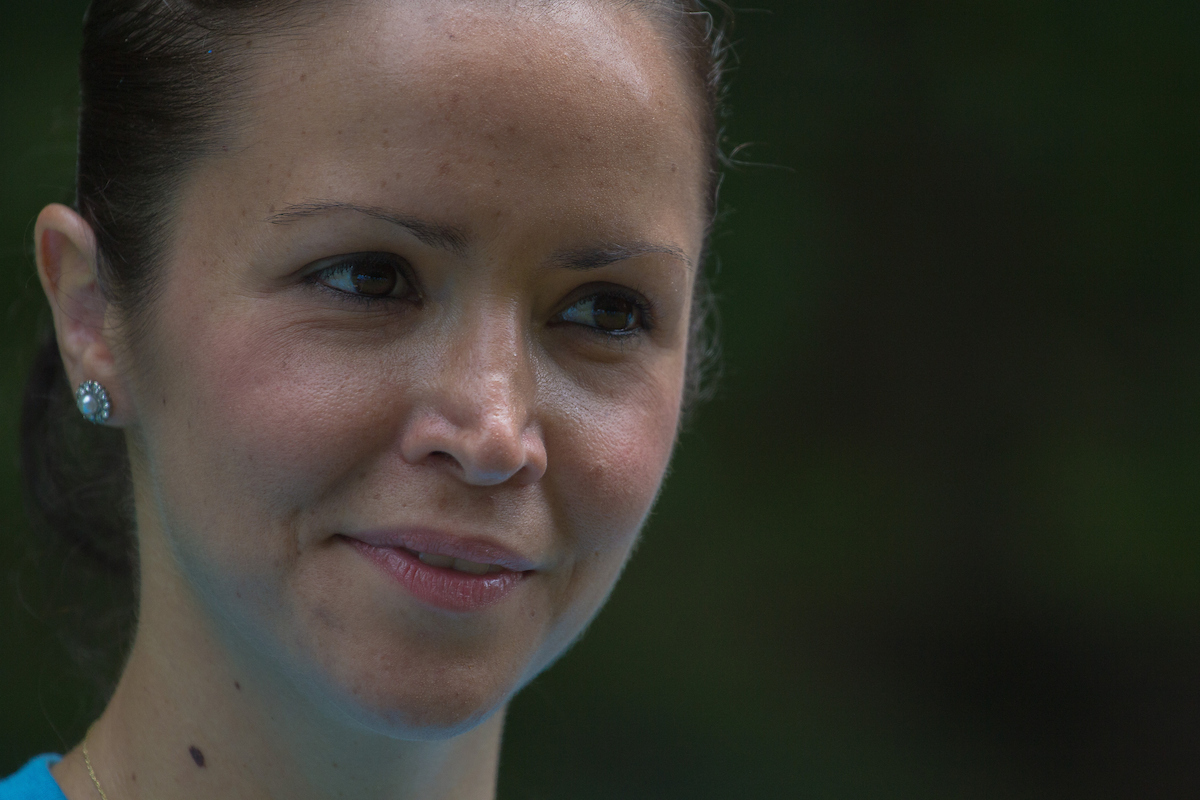 A close-up of a thoughtful woman contemplating a decision.