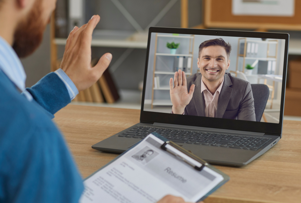 A video interview between two men in business suits.