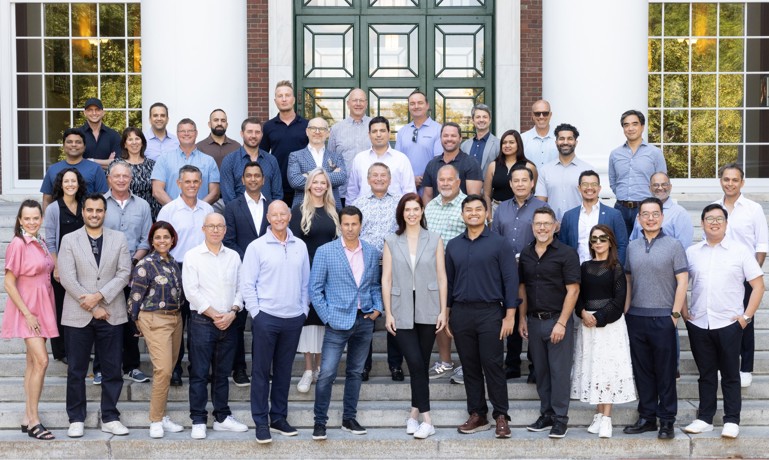 The 2025 cohort of Navigating Your Exit pose for a class photo at Harvard.
