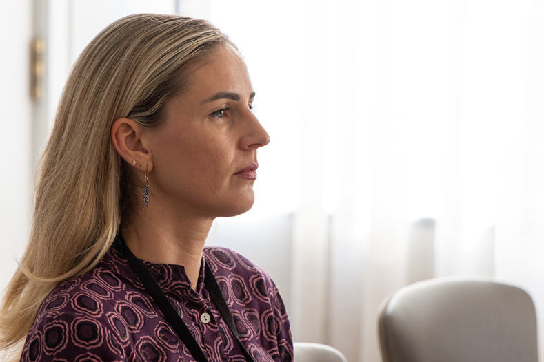 Profile of a woman with a pensive look on her face.