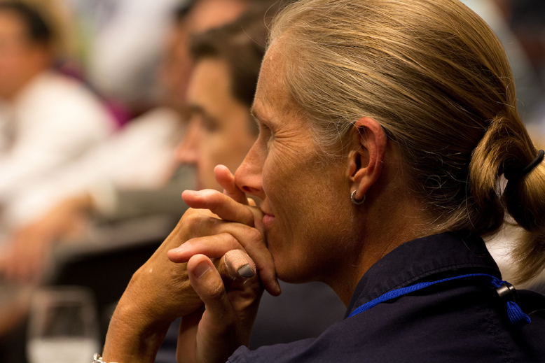 Profile photo of a woman resting her chin on her hands in deep thought