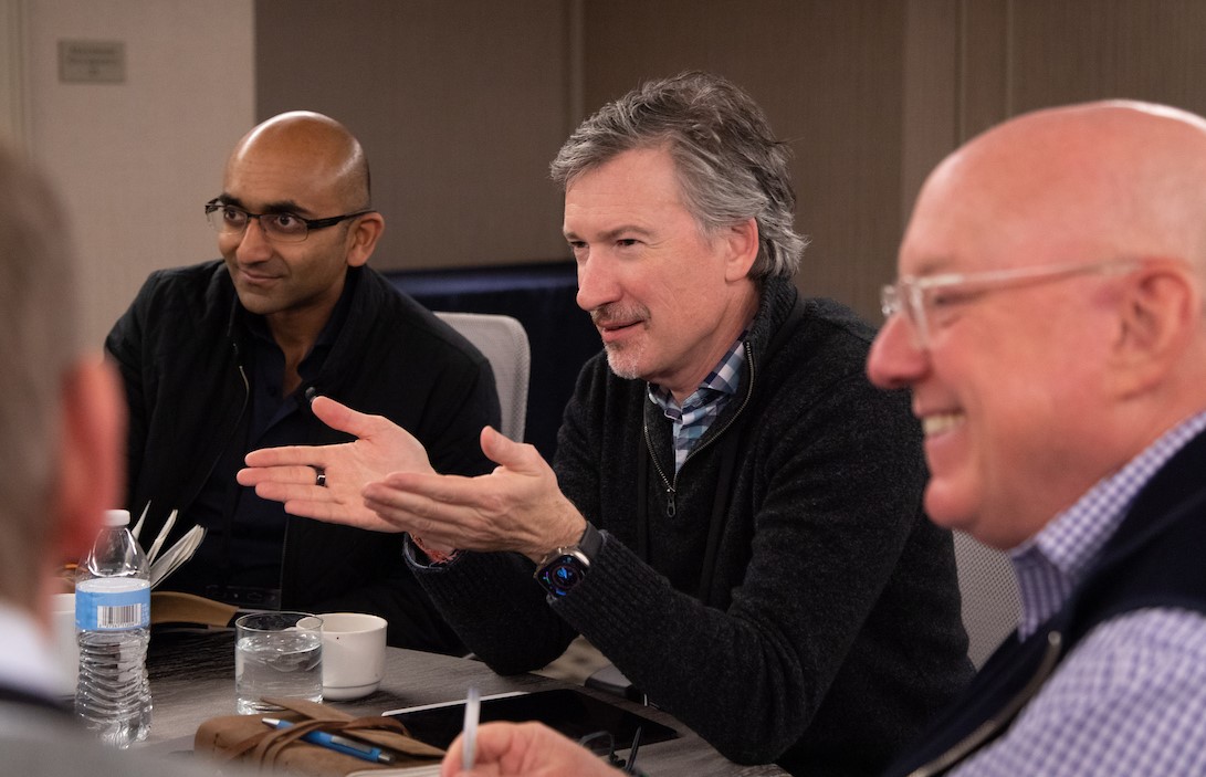 A group of businesspeople in a boardroom discuss important topics.